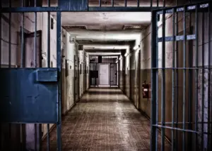 empty hall of a prison with prison bars