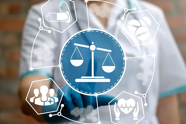graphic of a scales with health symbols around it in front of a torso of a medical professional