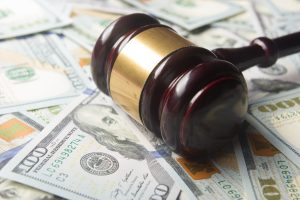 Judge's gavel on top of a pile of money