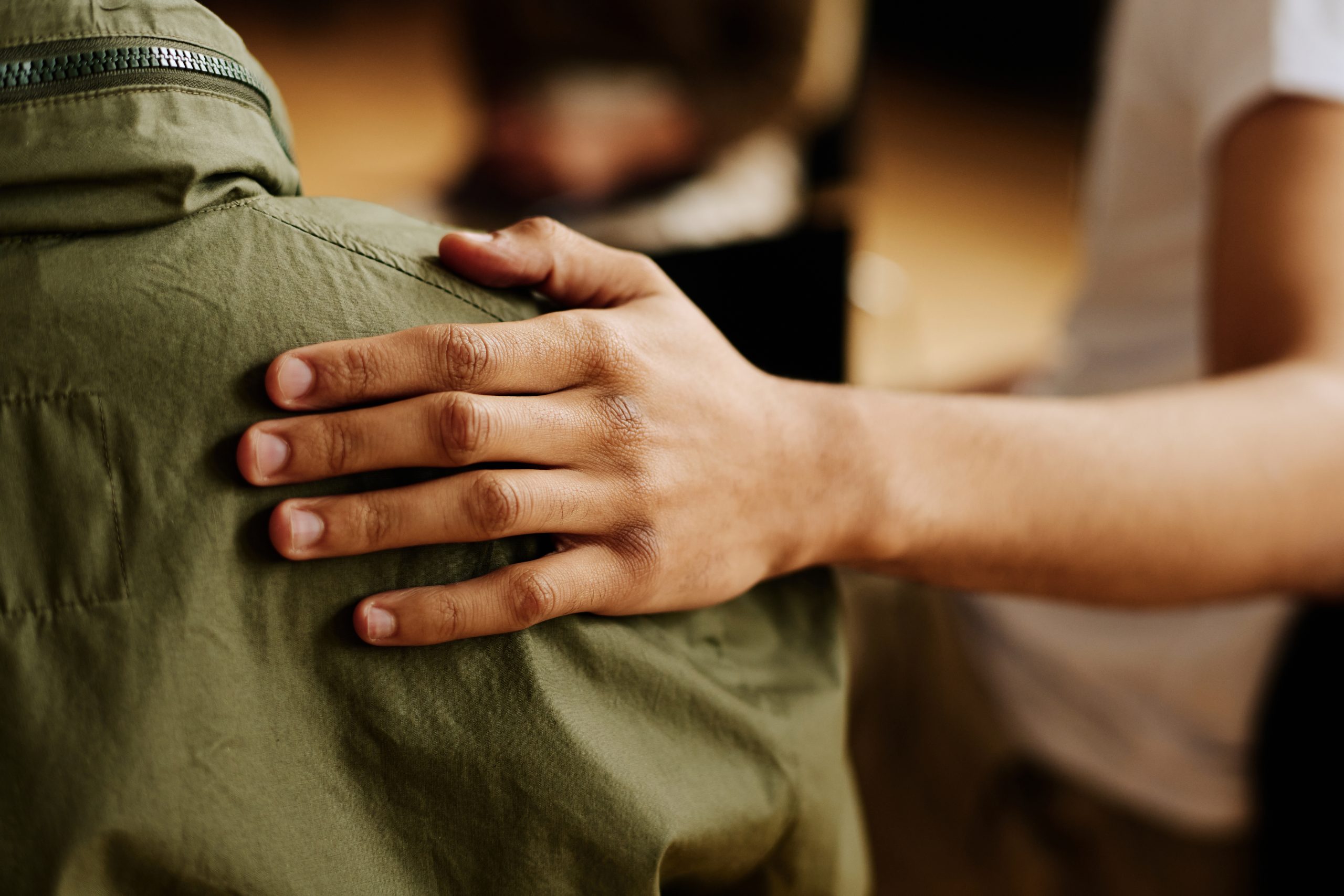 a hand on someone's back in a show of support
