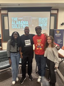 four people in front of a screen that says "the Alabama Solution"