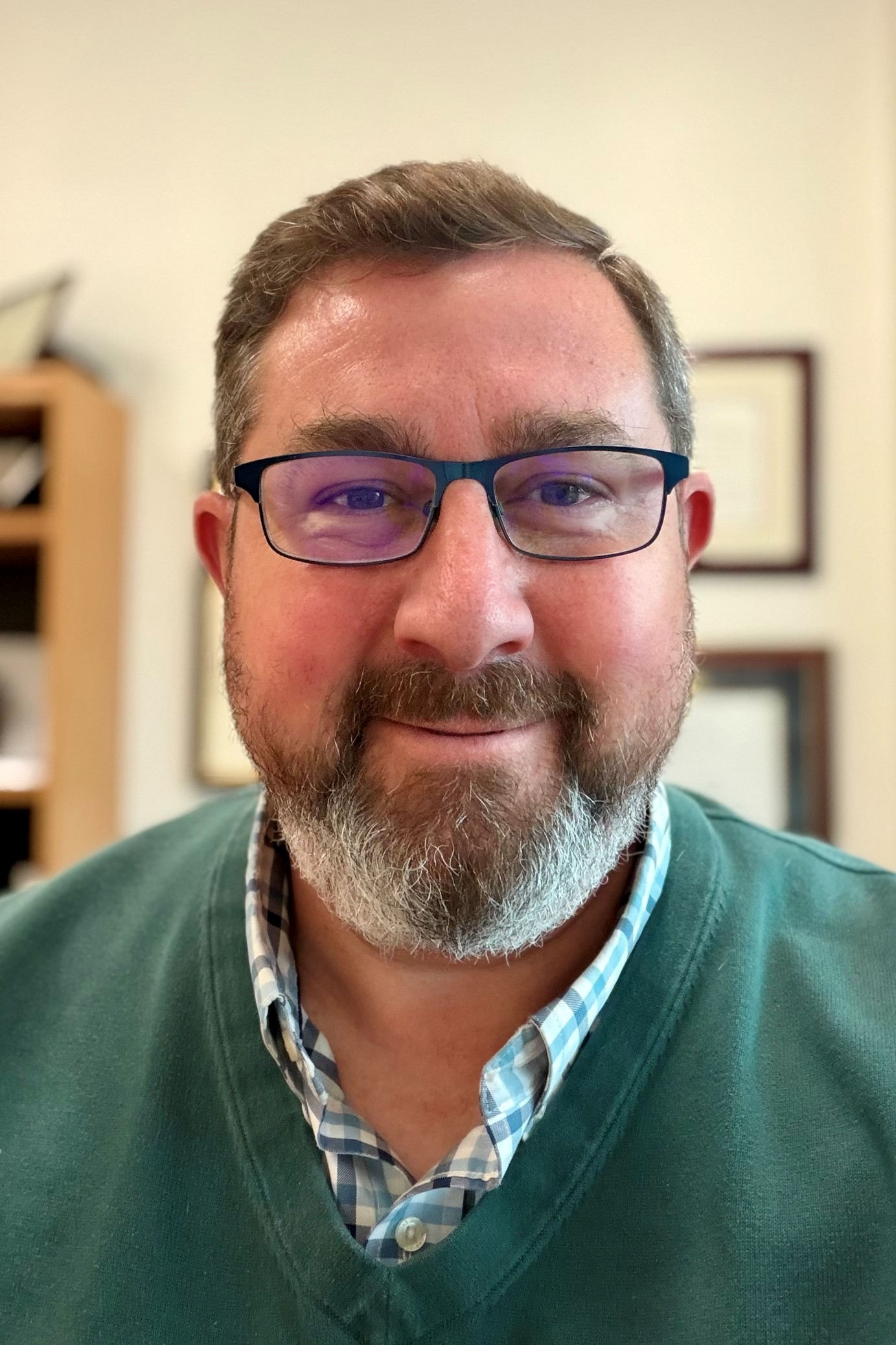 headshot of Ben Finholt wearing a green sweater